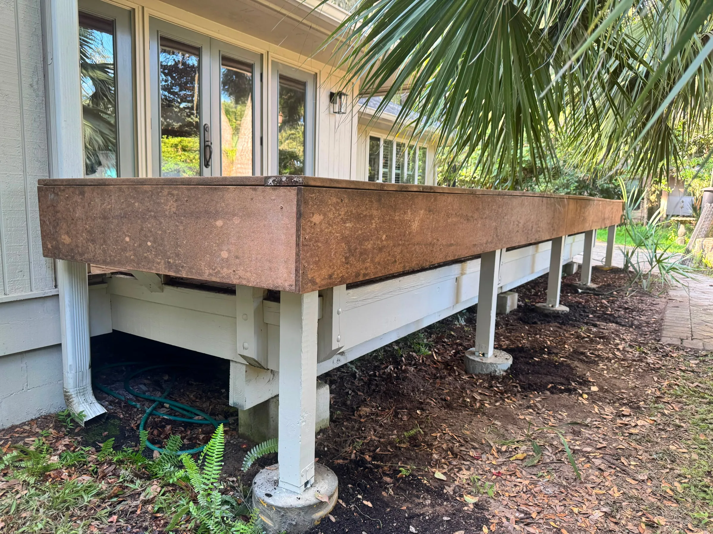 Additional posts added beneath the deck bench, set on footings and fixed down.
