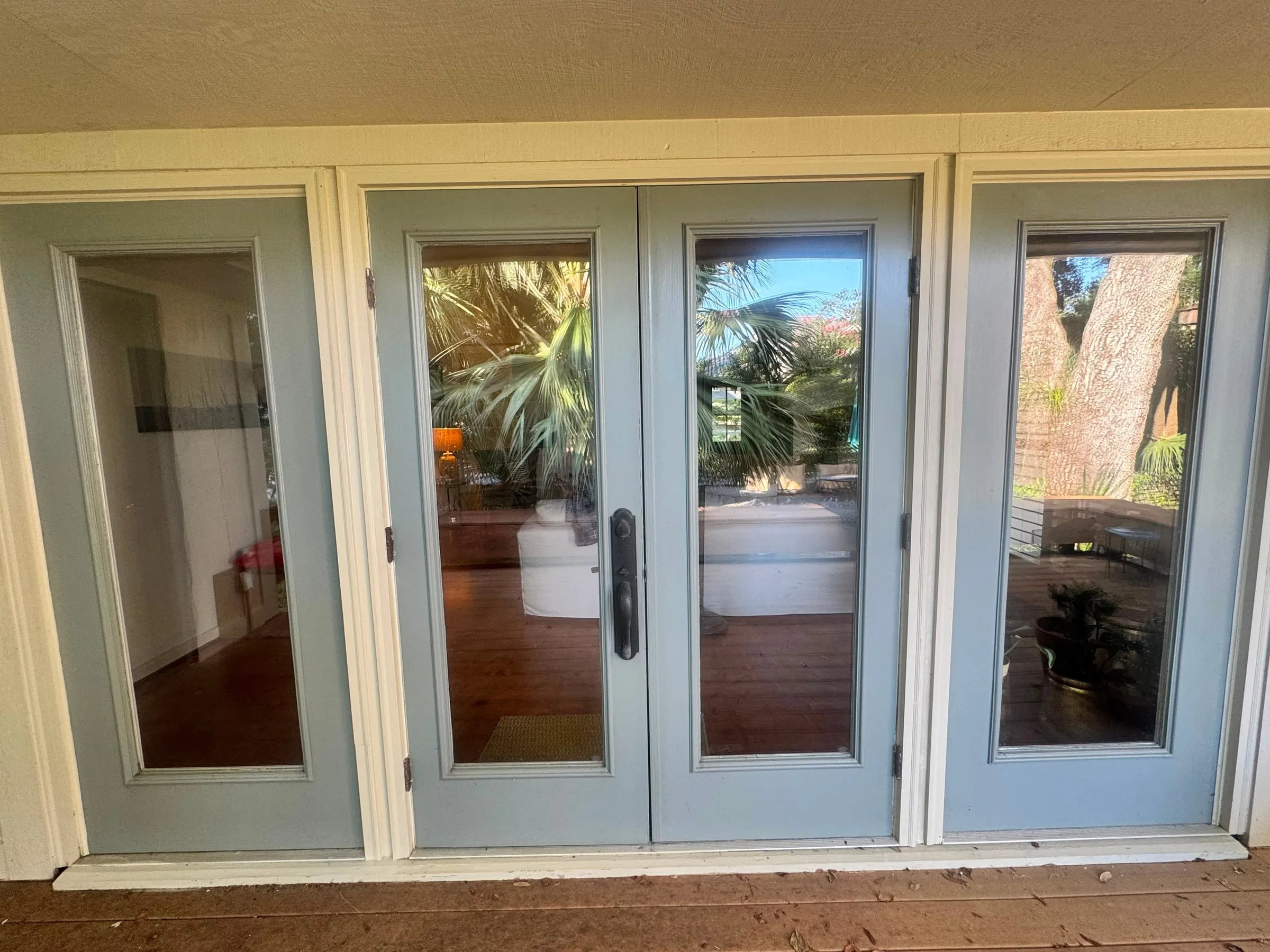 French doors and sidelights in rebuilt frames, painted to match the existing colour.