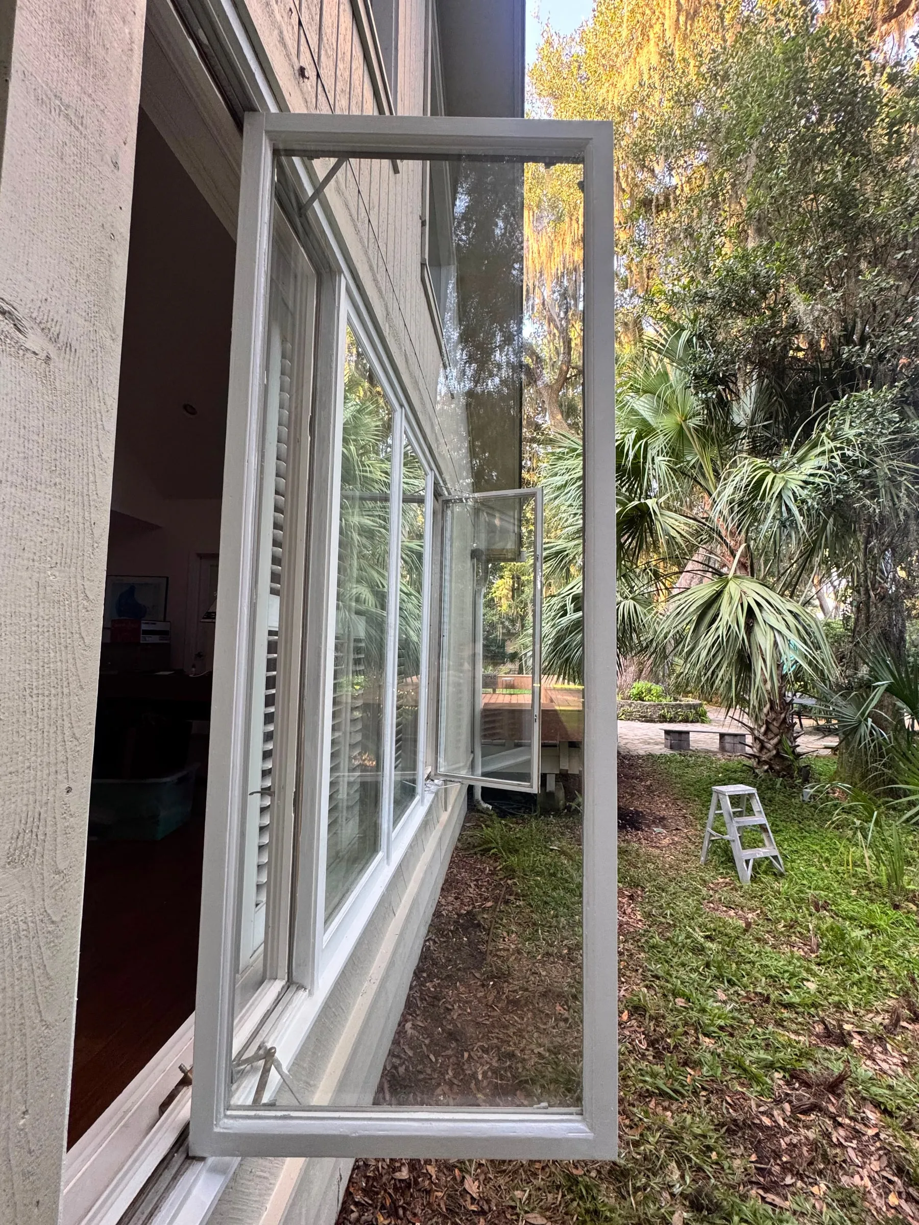 The glazed side of the house, looking down the window wall towards the garden.